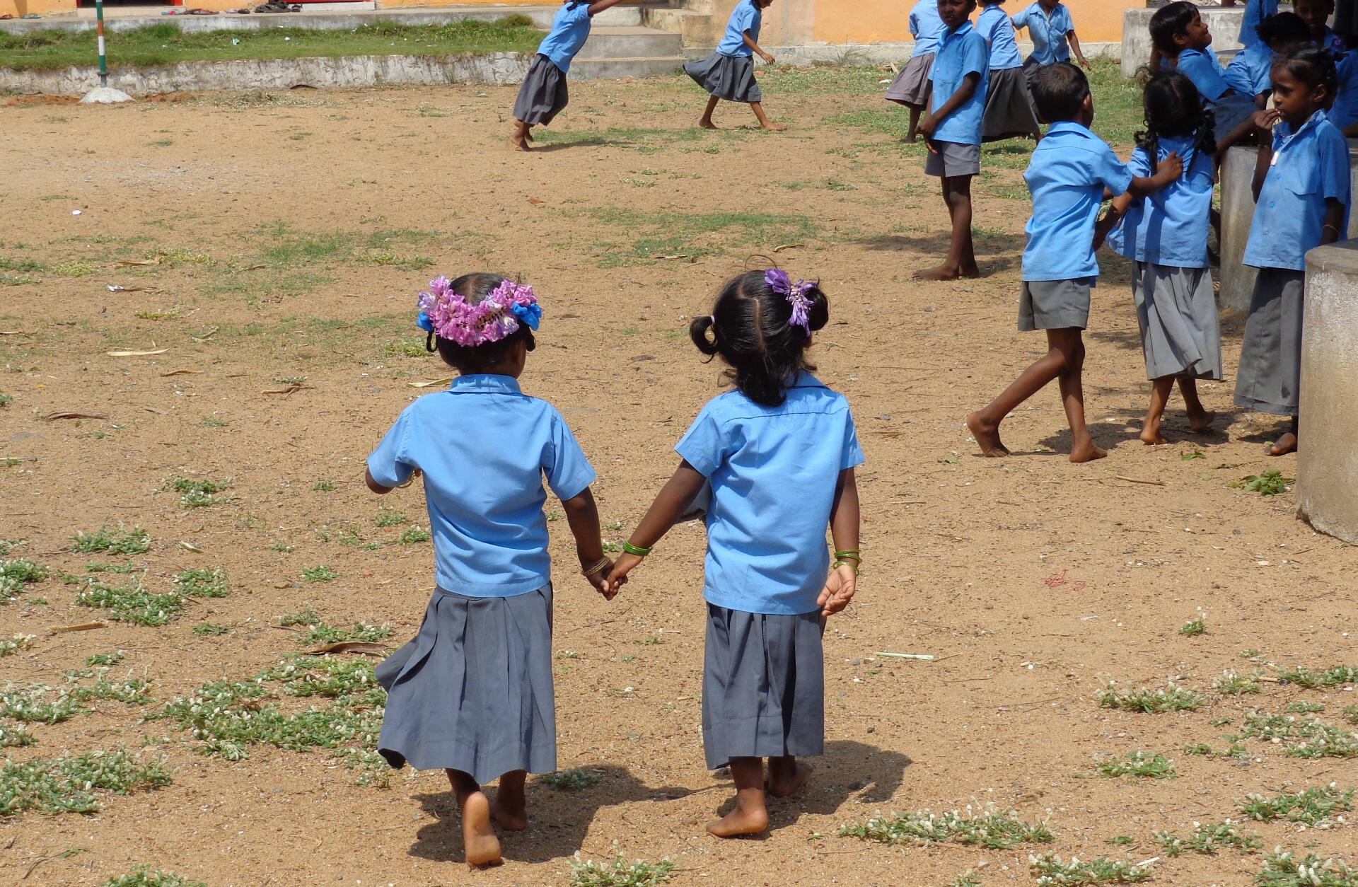 two young girls holding hands