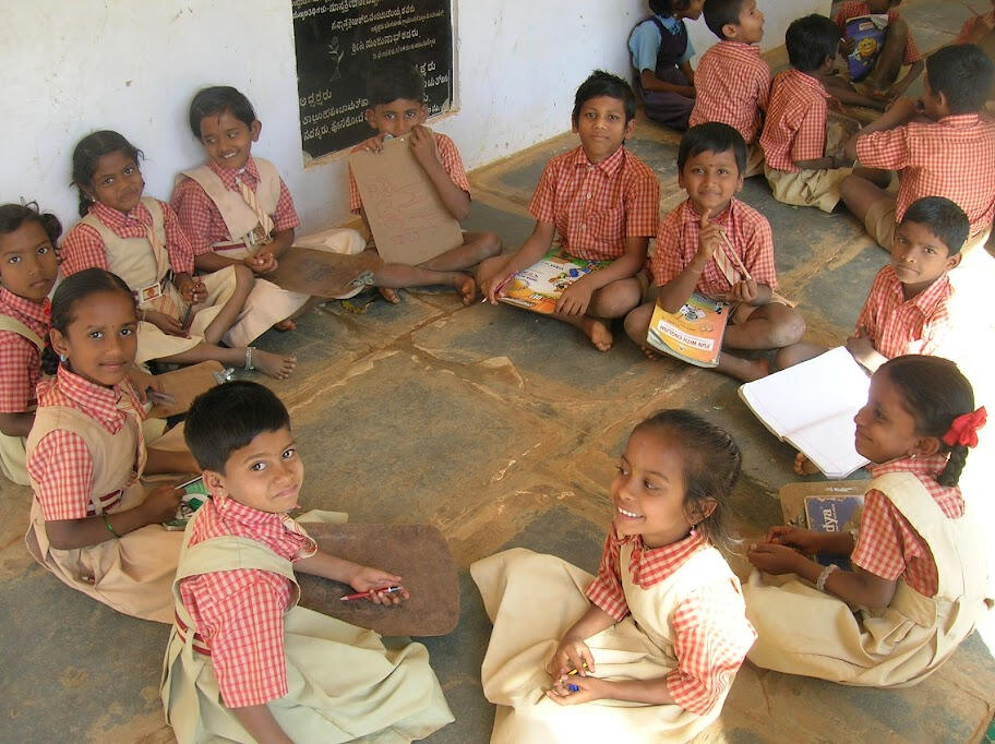 elementary students sitting on floor